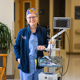 Physycian's assistant smiling with equipment